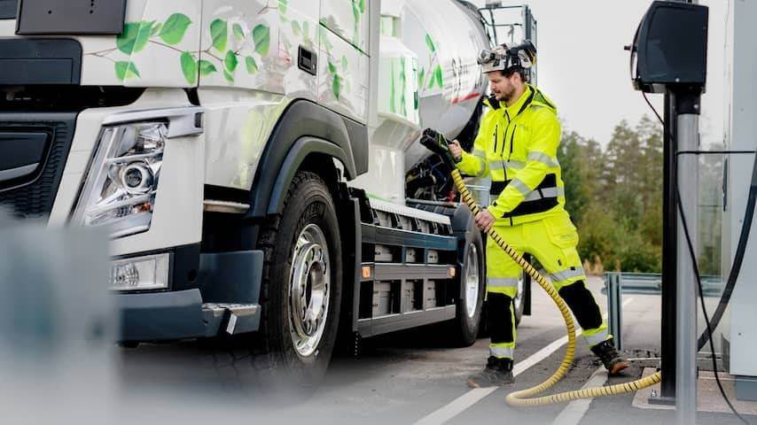 employee connecting electric truck at charging station